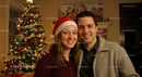 Couple Smiling Together by Festive Christmas Tree