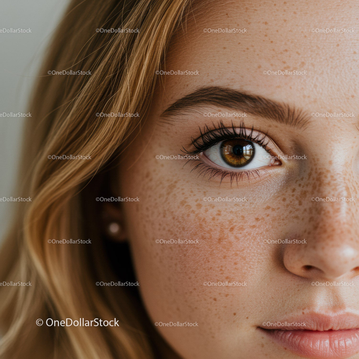 Close up of young woman with freckles and hazel eye
