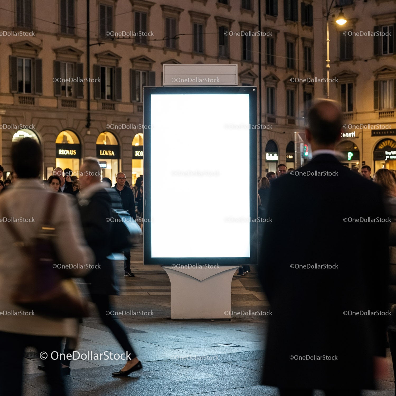 Urban evening crowd near brightly lit advertising display