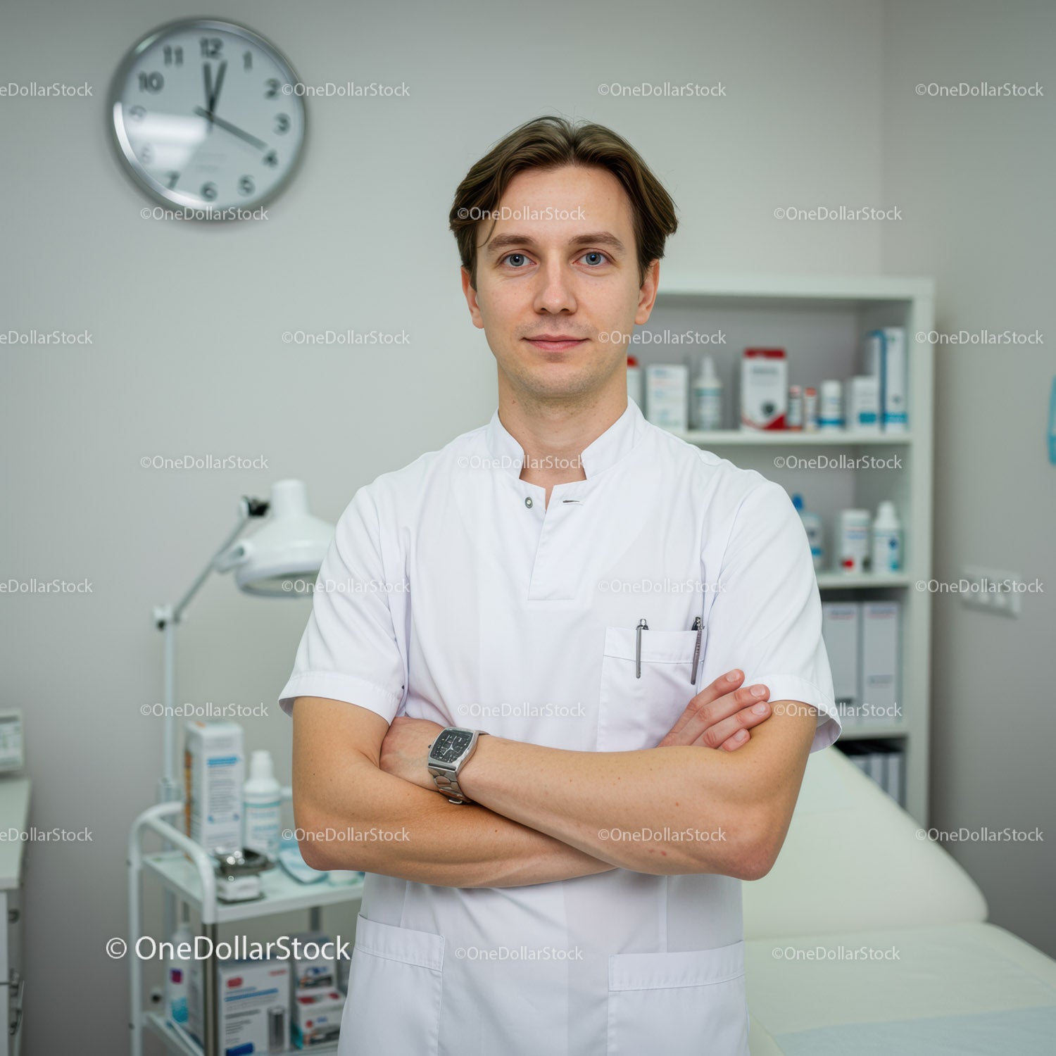 Young Male Doctor in White Coat Standing in Modern Clinic