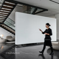 Blurred woman walking in modern minimalist lobby interior