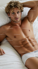 Relaxed young man lying on bed in white underwear