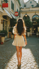 Stylish Woman Walking on Cobblestone Street in Summer City Scene