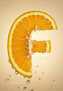 Orange slice shaped like vitamin C symbol with water droplets