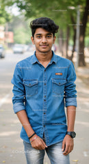 Young Man in Denim Shirt Standing Outdoors in Urban Park