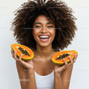 Joyful Woman Holding Fresh Papaya with Bright Natural Lighting