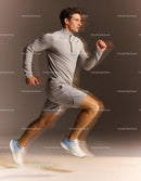 Athletic man running swiftly in light gray sportswear