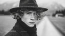 Black and White Portrait of Young Woman in Vintage Hat Outdoors
