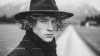 Black and White Portrait of Young Woman in Vintage Hat Outdoors