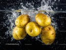 Fresh Yellow Apples in Water Splash with Vibrant Black Background
