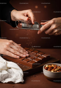 Chocolate Bar with Cacao Nibs and Assorted Nuts on Wooden Board