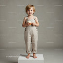Young blonde child holding cupcake on white platform