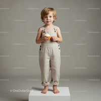 Young blonde child holding cupcake on white platform