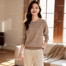 Smiling woman in cozy beige sweater at home