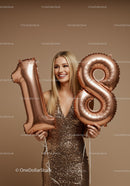 Smiling woman holding 18 number balloons in sequined dress