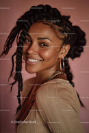 Joyful Smiling Woman with Braids and Golden Jewelry Portrait