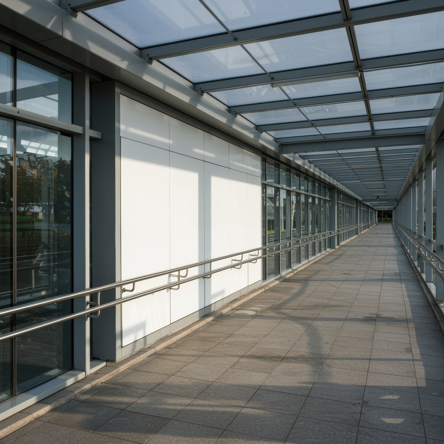 Modern Glass Corridor with Metal Handrails and Natural Light