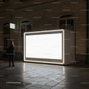 Woman Observing Illuminated Urban Billboard at Night