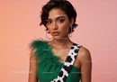Elegant Woman with Green Feathered Accessory and Leopard Print Strap