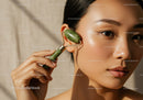 Close-Up of an Asian Woman Using a Jade Roller for Facial Skincare