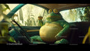 Humorous Green Frog in Car Surrounded by Tropical Nature