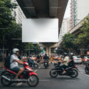 City street traffic with motorcycles riding past billboard
