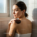 Young woman applying natural body scrub on her shoulder