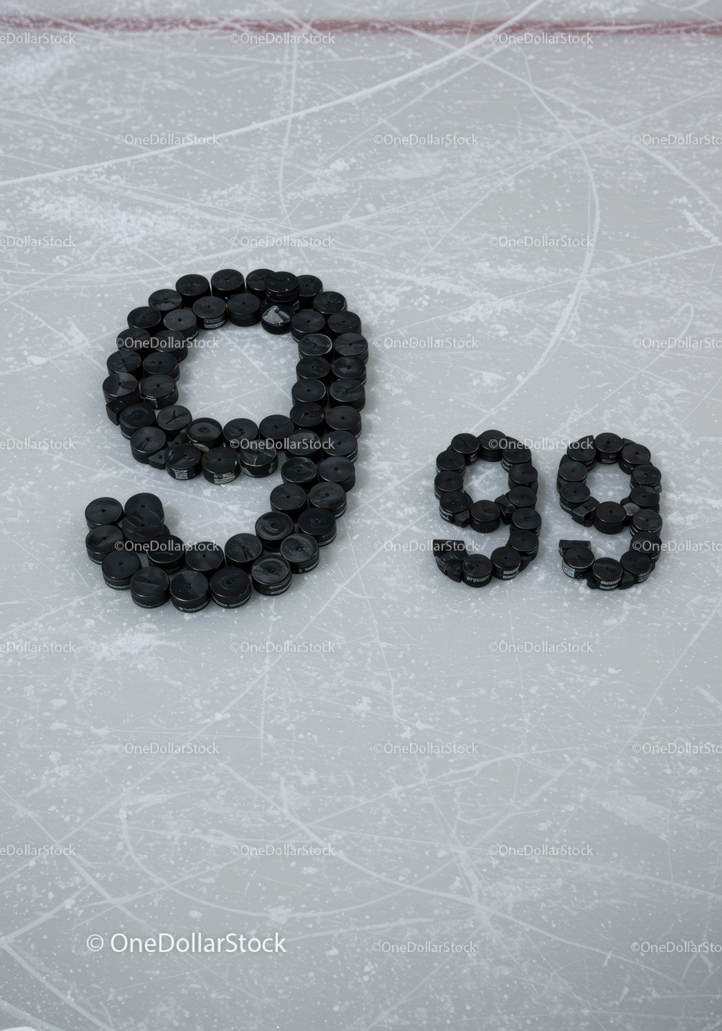 Number 99 formed with hockey pucks on ice rink surface
