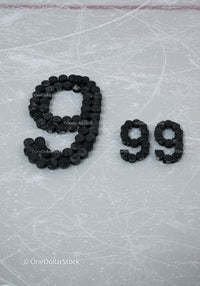 Number 99 formed with hockey pucks on ice rink surface