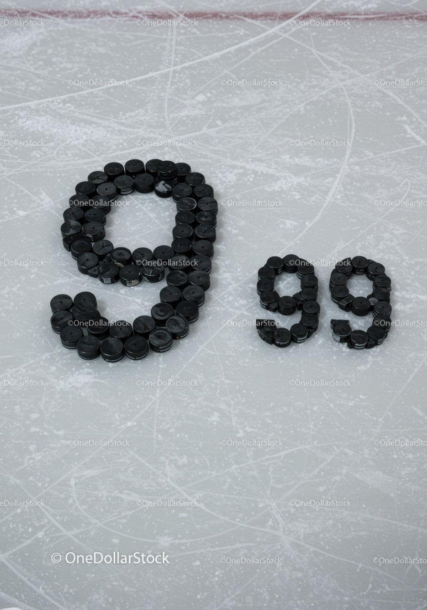 Number 99 formed with hockey pucks on ice rink surface