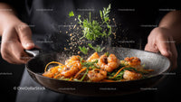 Shrimp Stir Fry with Fresh Herbs in a Black Pan