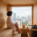Woman Relaxing in Wooden Sauna with City View