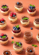 Assorted layered dessert jars with fresh berries and mint