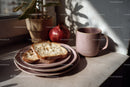 Fresh Bread Slices with Pink Mug and Pomegranate in Cozy Kitchen