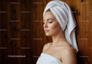 Relaxed Woman with Towel and Spa Setting in Wellness Center