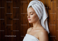 Relaxed Woman with Towel and Spa Setting in Wellness Center