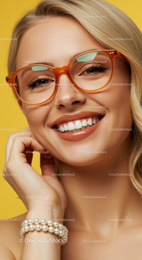 Smiling woman with orange glasses and pearl bracelet
