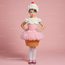 Little girl wearing creative cupcake costume in pink studio