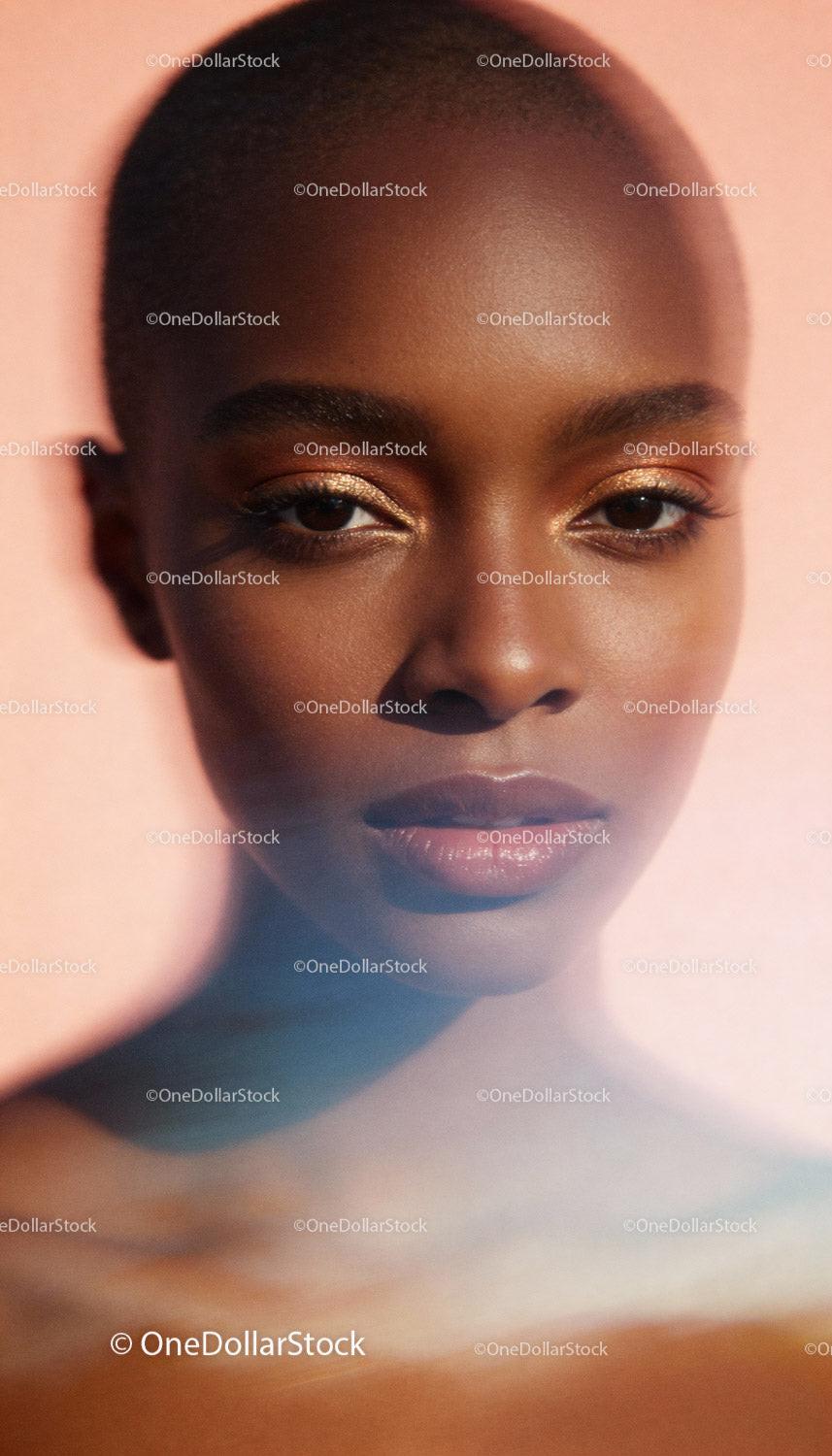 Close-up portrait of confident woman with glowing skin