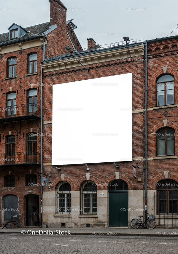 Historic brick building with blank outdoor billboard JPG Mockup Image