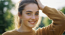 Young Woman Smiling Outdoors in Warm Weather