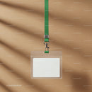 Blank ID badge with green lanyard on beige background
