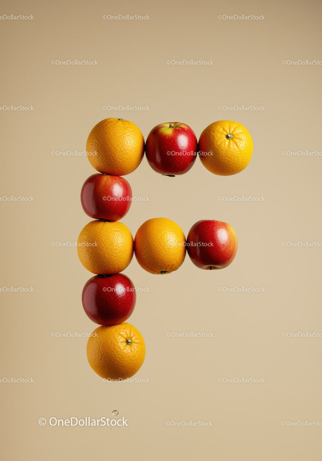 Letter F composed of fresh oranges and apples