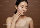 Young Woman Applying Moisturizer for Naturally Beautiful Skin
