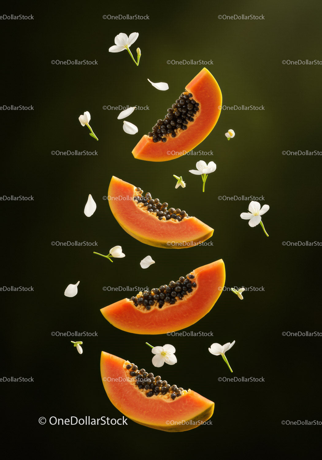 Fresh papaya slices surrounded by delicate white flowers