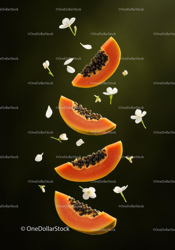Fresh papaya slices surrounded by delicate white flowers