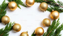 Golden Christmas Ornaments Framed by Fresh Pine Branches
