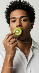 Young Man with Curly Hair Holding Kiwi in a Modern Minimalist Portrait