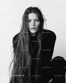 Elegant Black and White Portrait of a Confident Young Woman with Wavy Hair