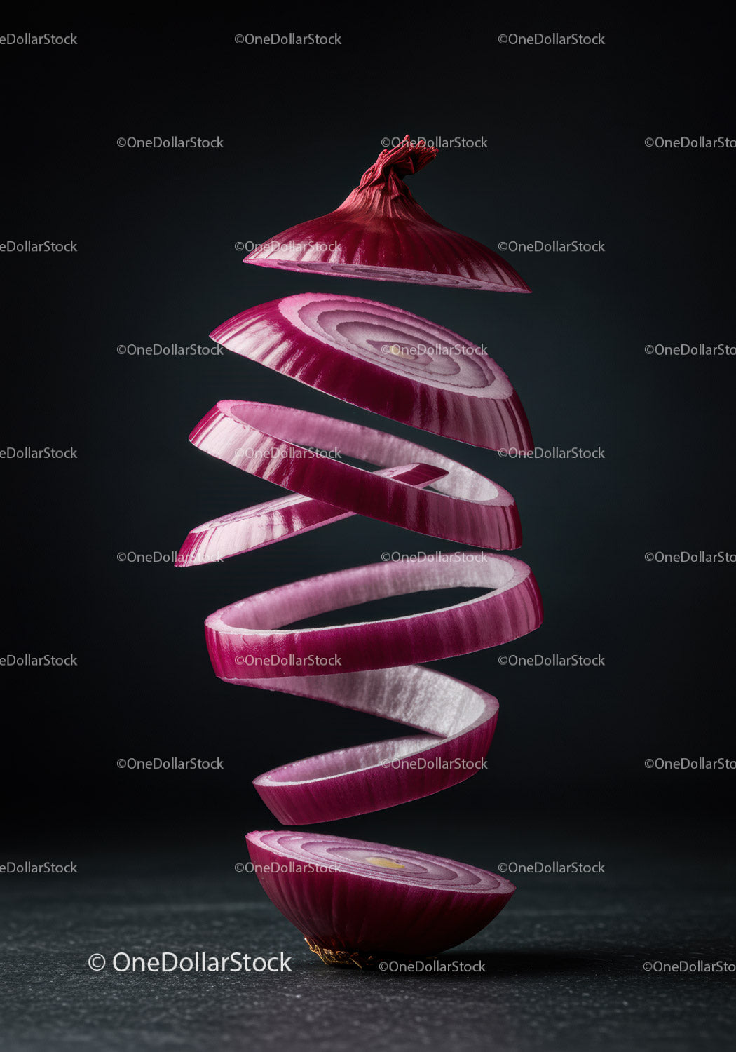 Red onion sliced in floating spiral layers on dark background